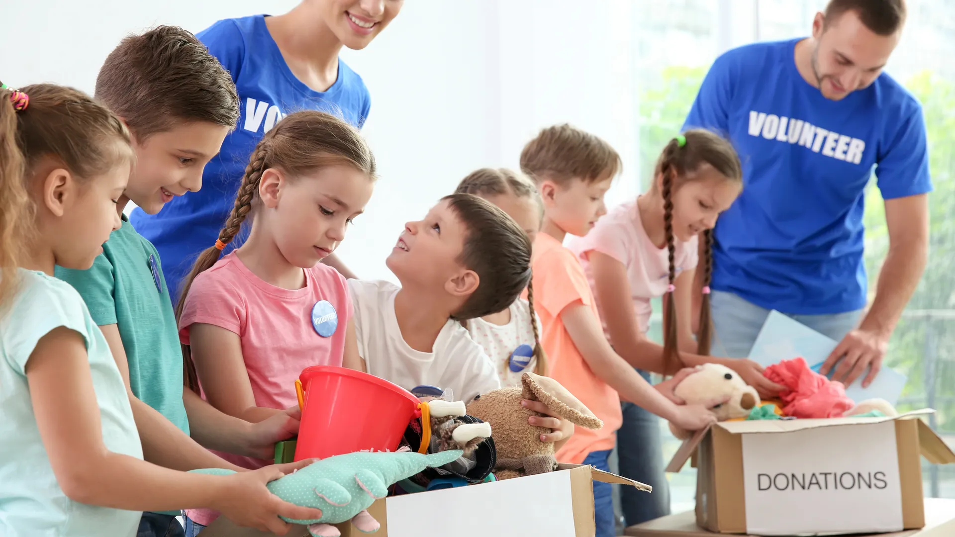 Children and adult volunteers working together at a community donation event