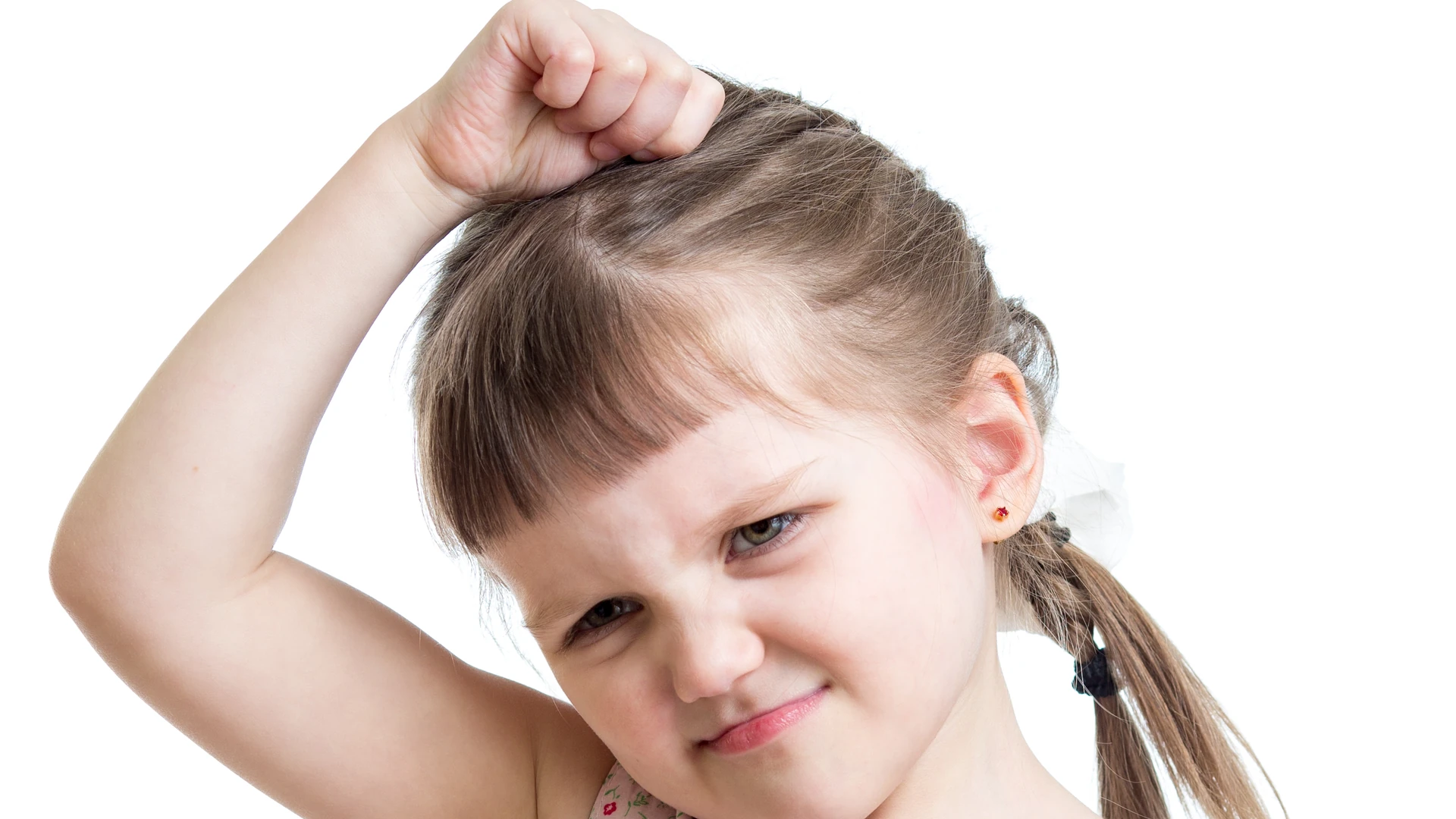 Young girl with pigtails grimacing as she scratches her itchy scalp